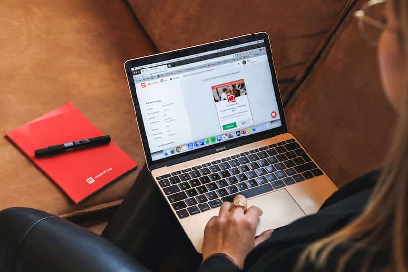 Person working on a laptop reviewing job descriptions